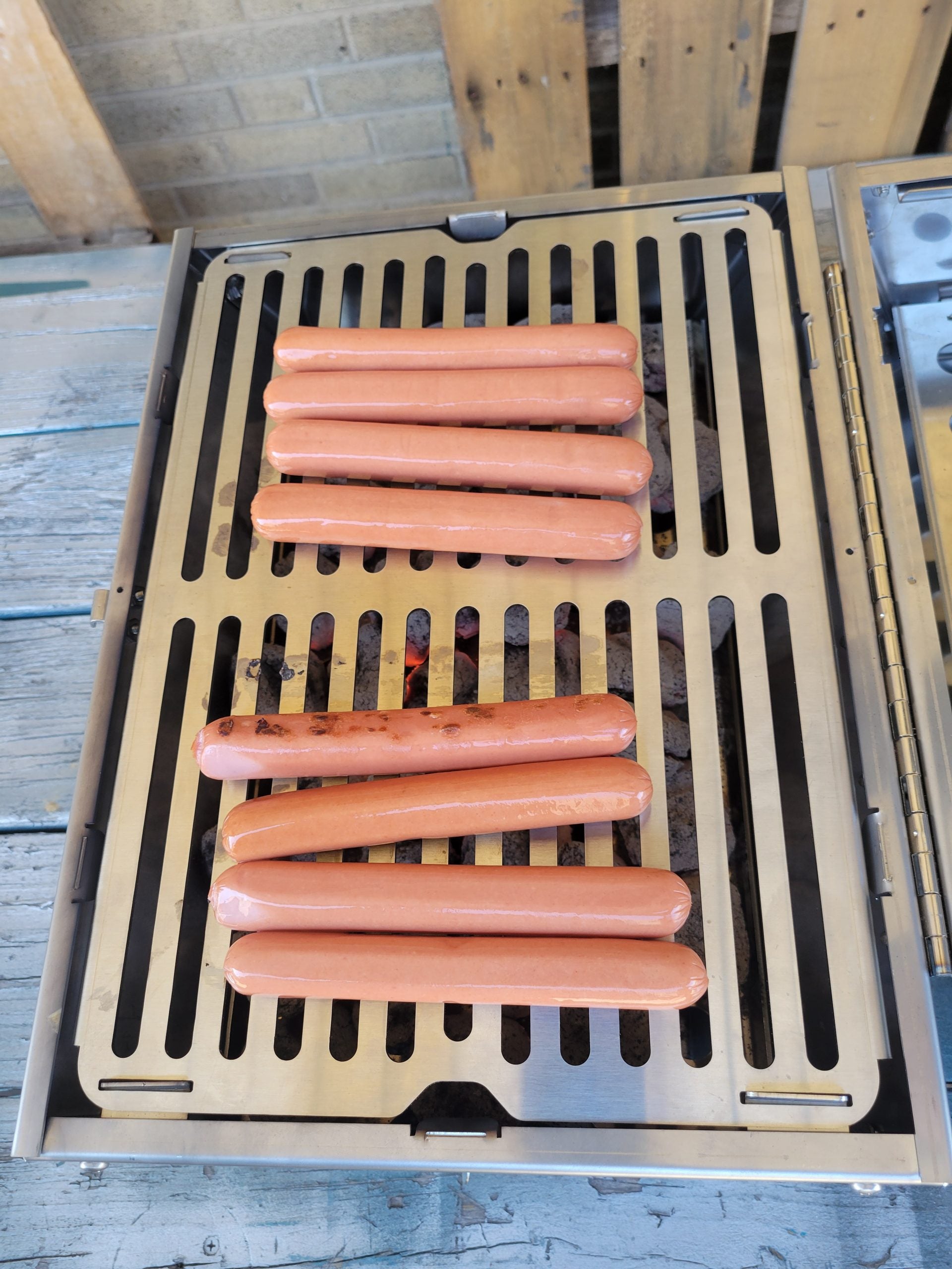 tsm-heavy-duty-portable-tool-box-grill;TSM-Toolbox-Charcoal-Grill-Infographic;side_view_of_the_portable_TSM_tool_box_grill;closed_position_of_the_tool_box_grill;21-lb-heavy-duty-portable-grill-to-last-a-lifetime;cooking_sausages_on_grill;some_vegetables_and_chicken_wings_on_TSM_tool_box_grill