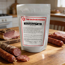A pouch of InstaCure #2 natural cured sausage mix, displayed on a wooden cutting board with raw and sliced sausages in the foreground and a blurred kitchen background.