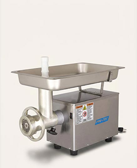 Pro Cut #12 electric meat grinder on a beige background