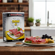 SauageMaker Salami Kit packaging with a plate of salami sandwiches and ingredients on a kitchen counter.