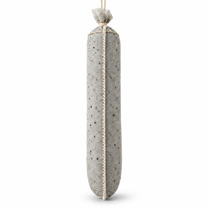 Showing a light gray, stuffed black pepper spice-lined sausage casing hanging on a white background.