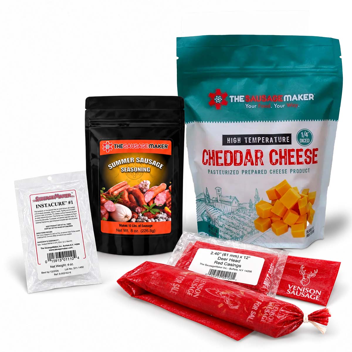 A product bundle from The Sausage Maker, including a large bag of cheddar cheese, a black pouch of summer sausage seasoning, a small white packet of instant cure, and two red venison printed fibrous casings, arranged on a white background.