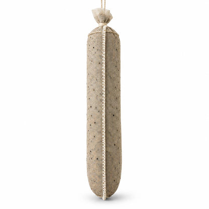 Showing a beige colored, stuffed red pepper spice lined sausage casing hanging on a white background.
