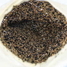 A close-up view of the inside of the black pepper spice-lined sausage casings.