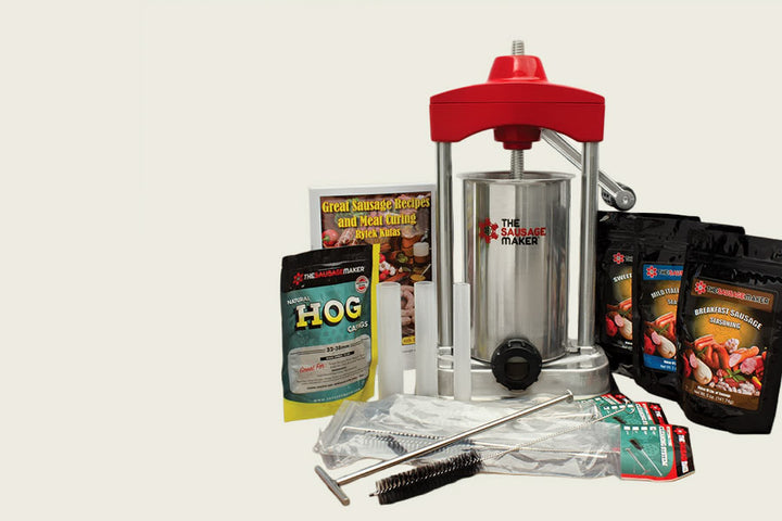 Sausage maker with accessories and ingredients on a white background