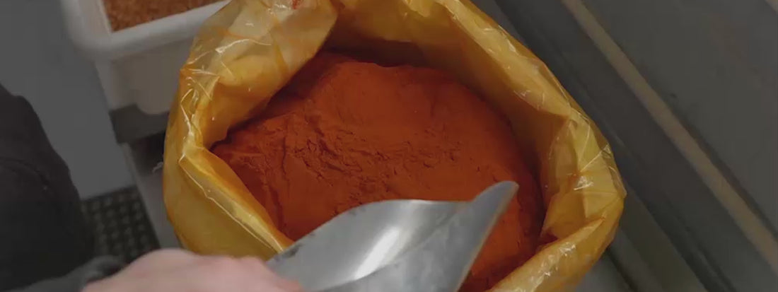 Load video: A home chef crafting g sausage using sausage maker's casing, spice and grinder